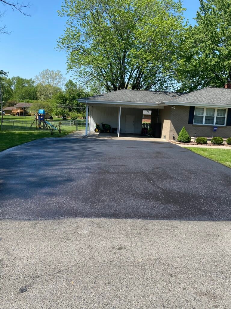 Sealcoated residential driveway beside a home in Evansville