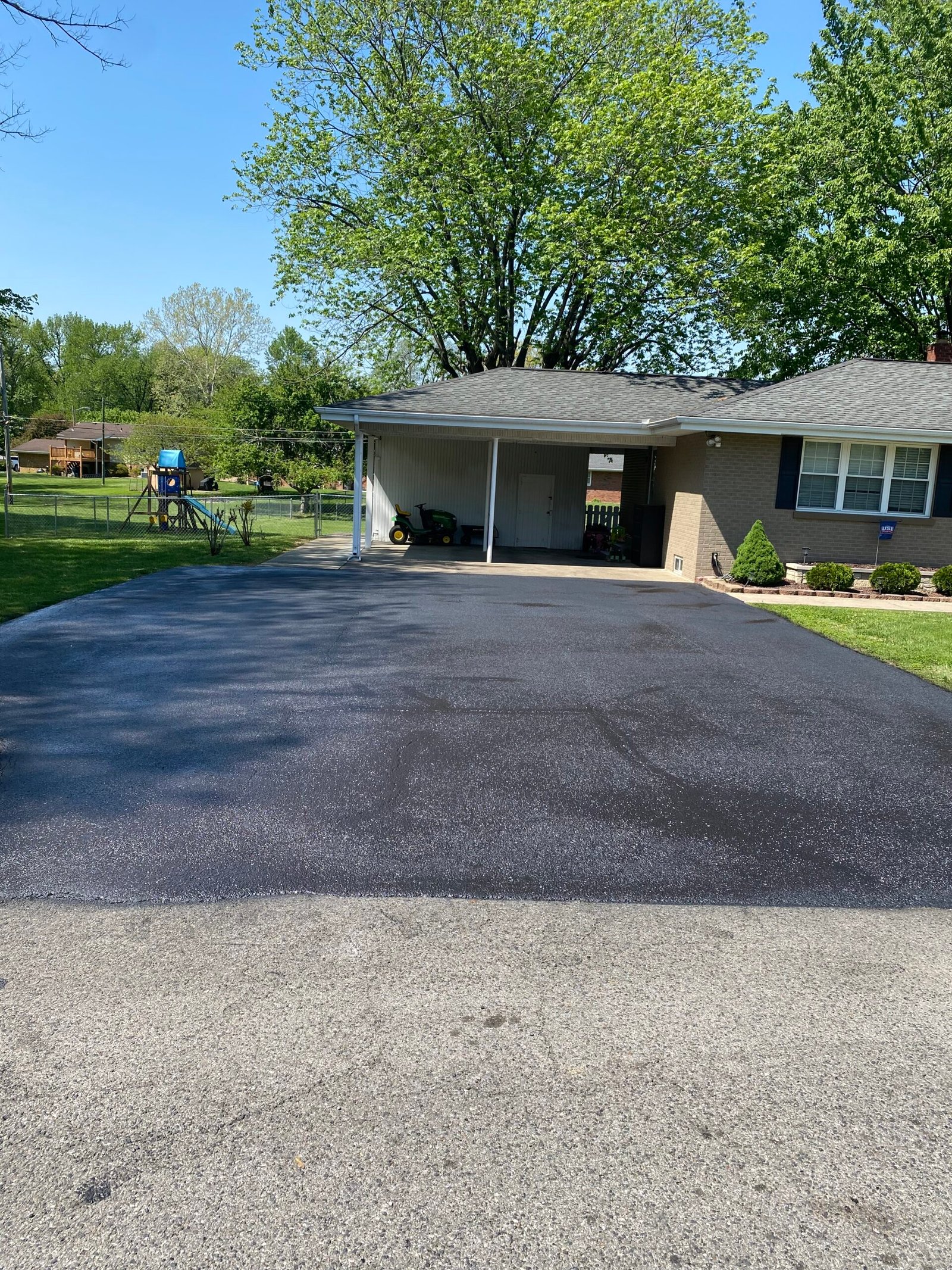 Freshly sealcoated residential driveway in Evansville, Indiana