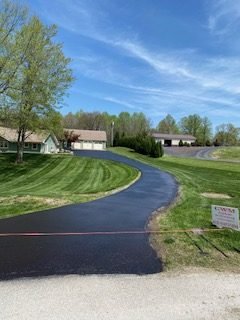 Curved Tell City driveway after sealcoating