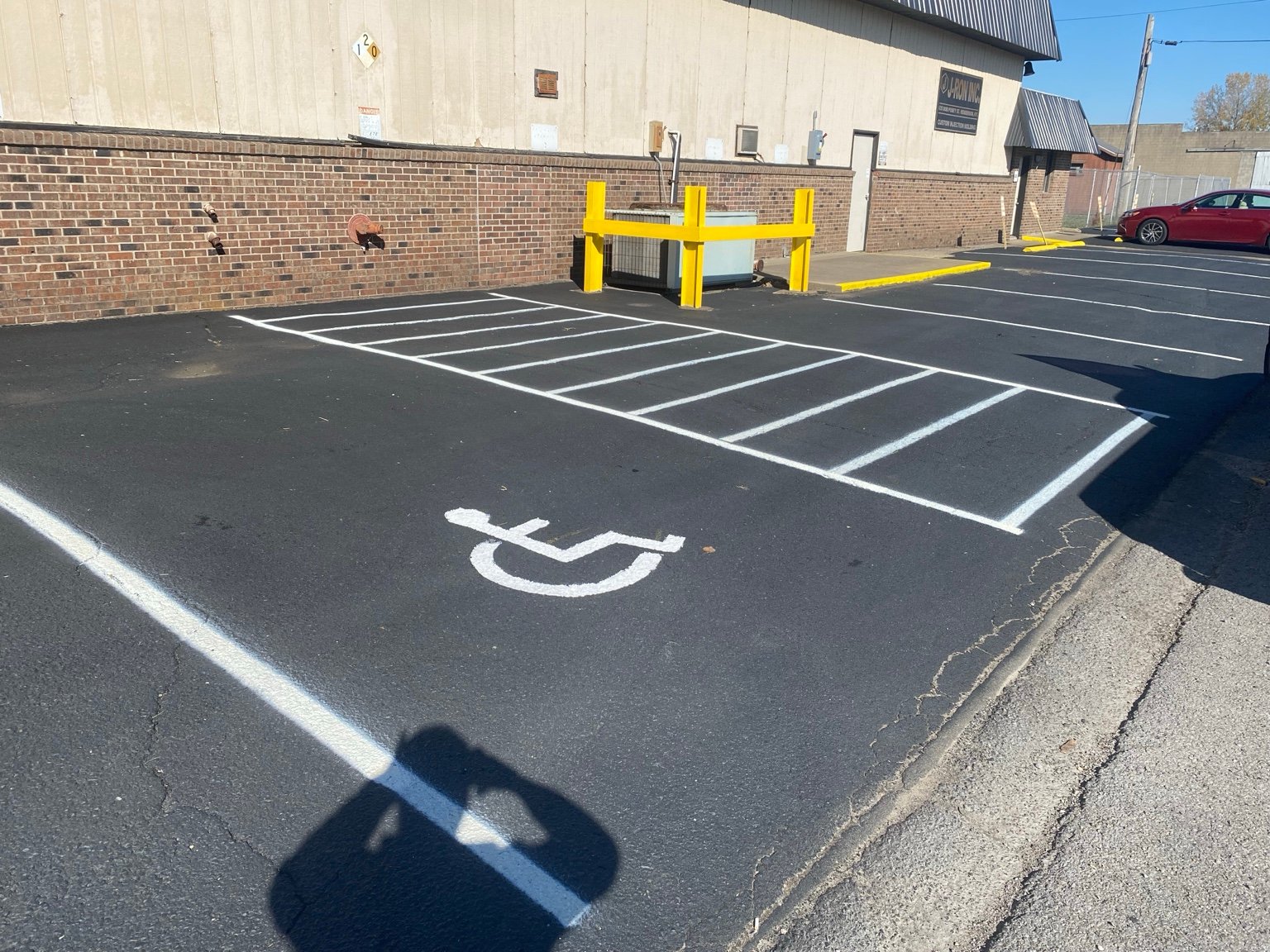 Accessible parking symbol and striped access aisle at J-Ron Inc. Henderson KY
